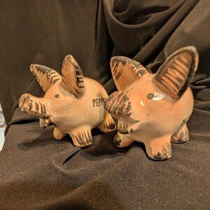 Ceramic pig-shaped salt and pepper shakers marked 'SALT' and 'PEPPER'